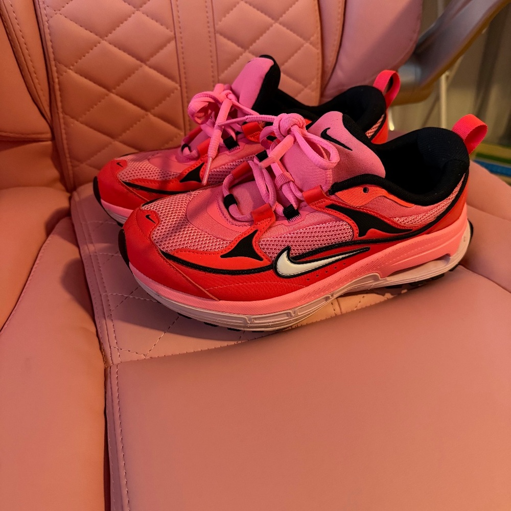 Pink and red woman’s Nikes